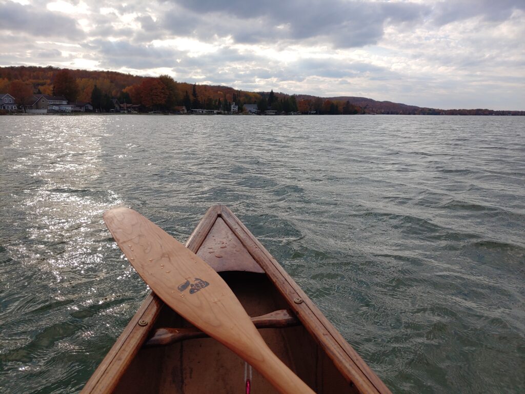 Canoe front in water with paddle