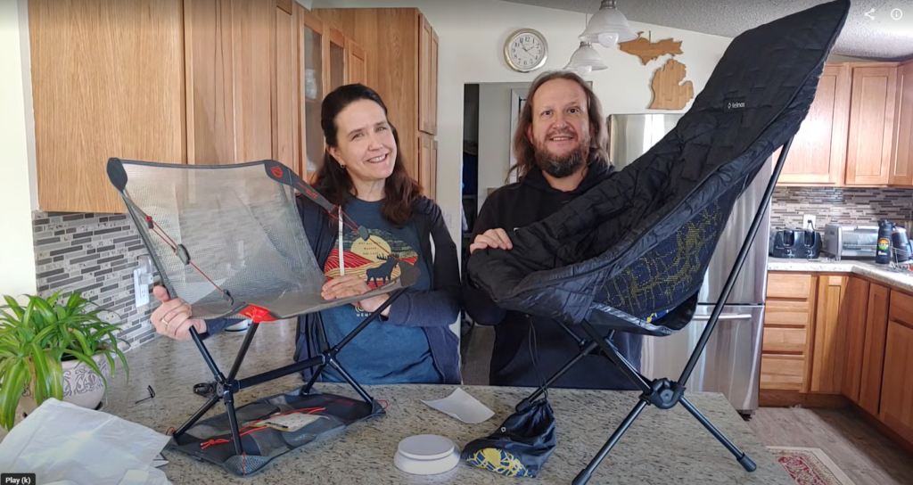 two people with camping chairs in a kitchen