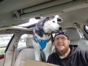 Man and dog in car